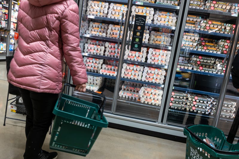 A person shops for eggs at a Whole Foods Market grocery store in December. Grocery prices have recently seen their most significant monthly gain since January of 2023 with egg prices rising 8.2% alone. 