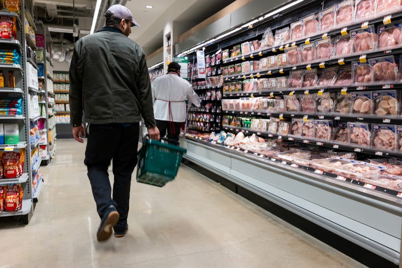 A person shops at a Whole Foods Market grocery store.
