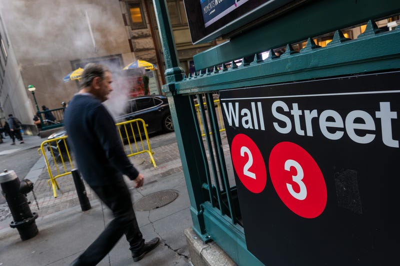 People walk outside of the New York Stock Exchange (NYSE) this month
