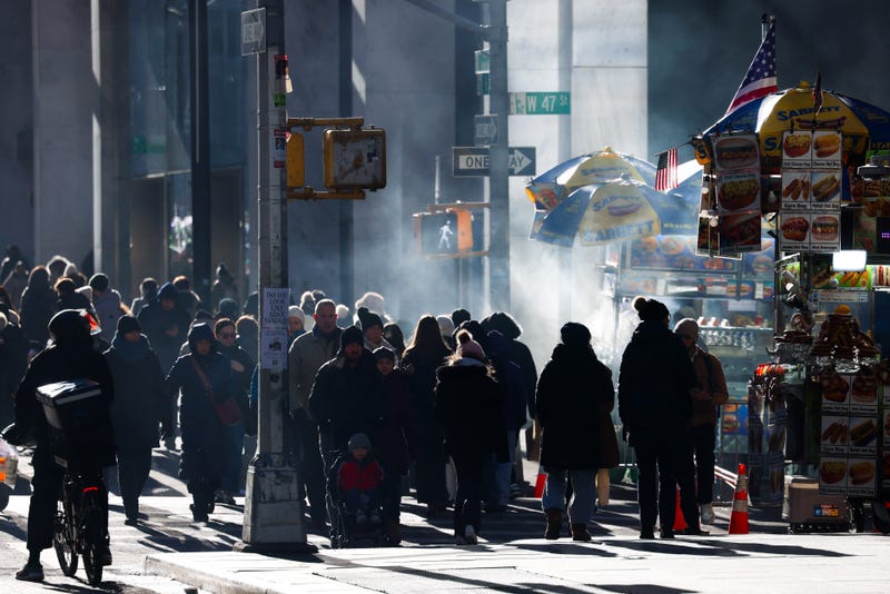 People walk along Sixth Avenue on a cold Dec. 23, 2024