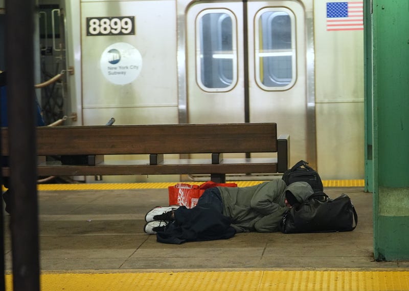 An unhoused person taking shelter in a subway station on Dec. 22, 2024.
