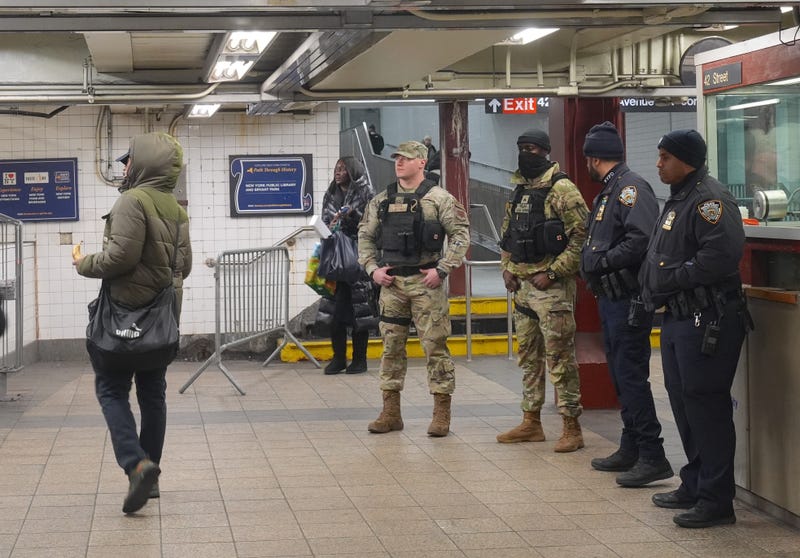 National Guard members are seen alongside police officers in the subway system on December 23, 2024