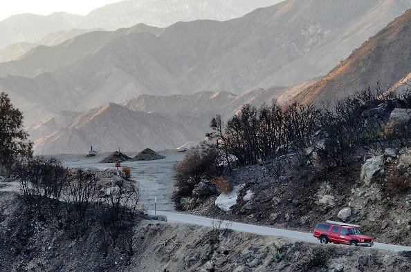 ECEMBER 19: An aerial view of a vehicle parked on a closed road in the Bridge Fire burn recovery zone in the Angeles National Forest on December 19, 2024 near Mount Baldy, California. A number of trails and roads in the Mount Baldy area, including trails to the popular Mount Baldy summit, are closed in order to promote safety and recovery from the 56,000 acre Bridge Fire which burned in Los Angeles and San Bernardino counties. People caught hiking in the closure area face a potential $5000 U.S. Forest Service fine with some believing the government regulations are overly onerous. (Photo by Mario Tama/Getty Images)