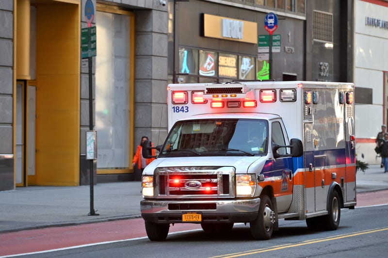 n ambulance rides with a siren on a call on the street in Manhattan.