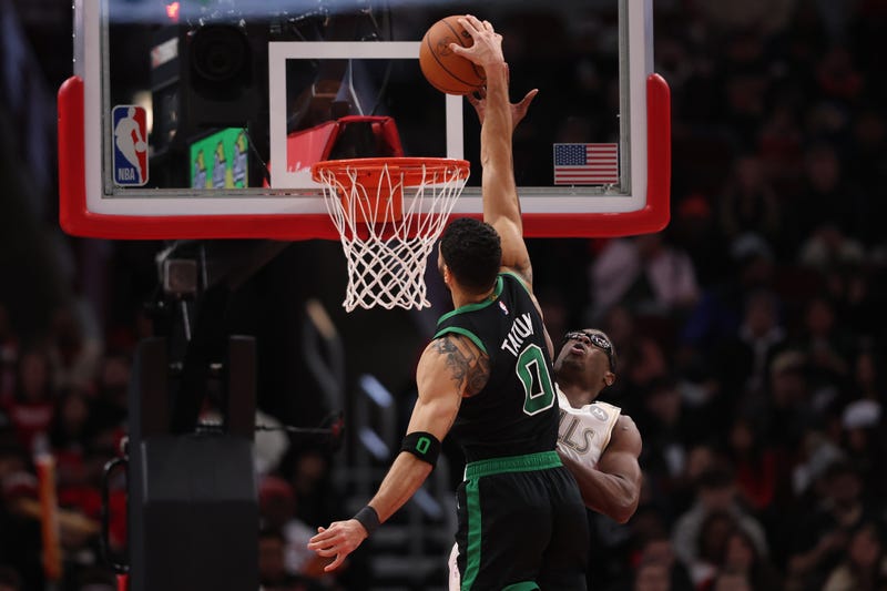 Jayson Tatum #0 of the Boston Celtics dunks on Jalen Smith #7 of the Chicago Bulls during the second half at the United Center on December 21, 2024 in Chicago, Illinois.