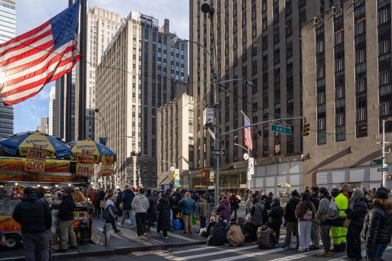Revelers wait in line on Sixth Avenue to clear security prior to entering Times Square on December 31, 2024.