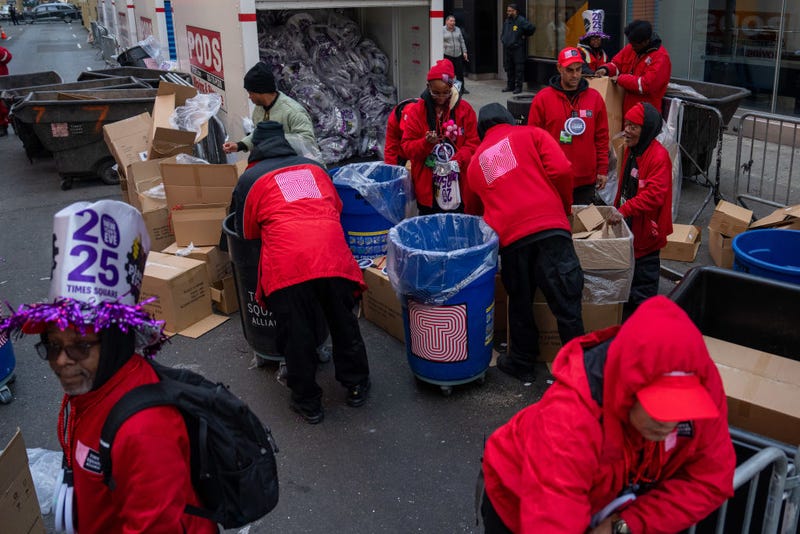 Members of the Times Square Alliance prepare to distribute party favors to revelers on December 31, 2024.