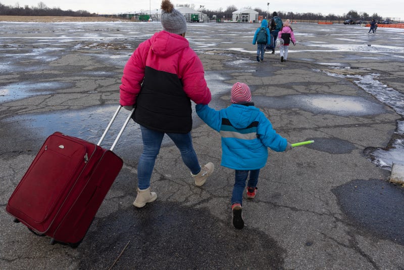 Migrant families leave the Floyd Bennett Field migrant shelter in Brooklyn on December 25, 2024. An influx of asylum seekers contributed to an increase in homelessness in New York, the report says
