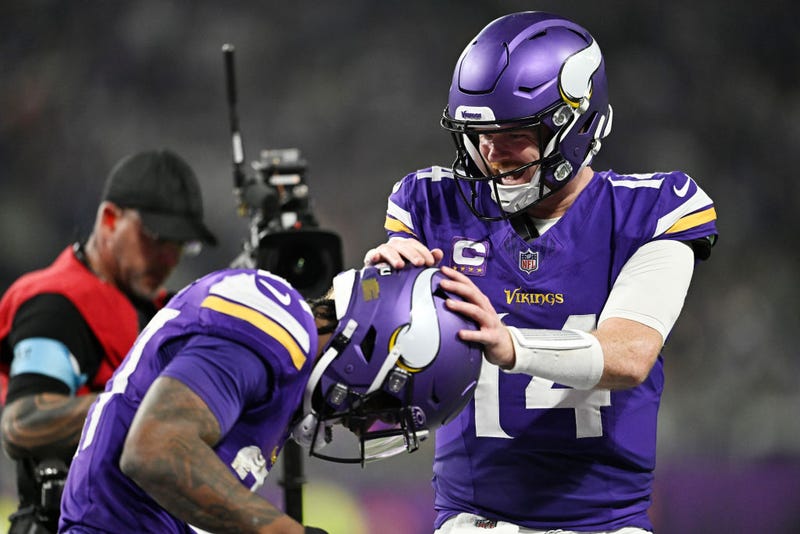 Cam Akers #27 and Sam Darnold #14 of the Minnesota Vikings celebrate a third quarter touchdown from Akers against the Green Bay Packers at U.S. Bank Stadium on December 29, 2024 in Minneapolis, Minnesota.