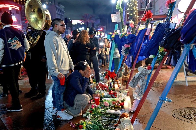 A man and woman grieve in front of a cross dedicated to Bourbon Street terror attack victim Nicole Perez at a memorial on Canal Street near Bourbon Street on January 4, 2025 in New Orleans