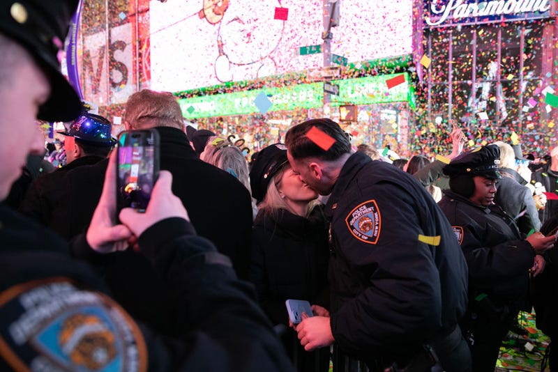 A couple kiss as confetti falls over Times Square to celebrate the New Year of 2025 on Jan. 1, 2025.