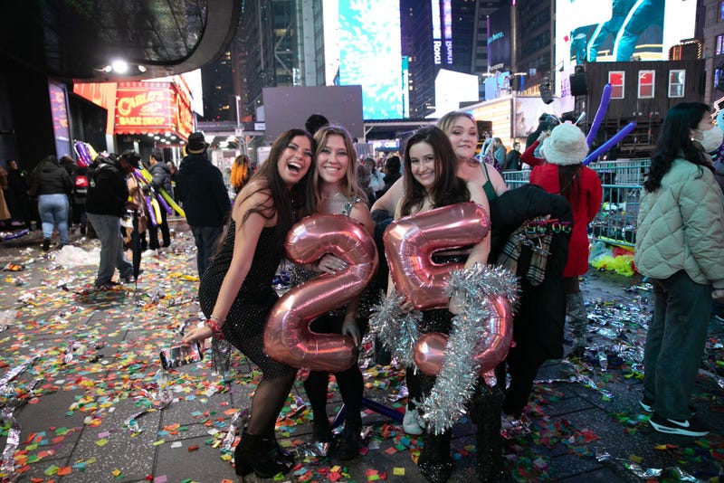 Revelers holding balloons pose in Times Square to celebrate the New Year of 2025 on Jan 1. 2025 in New York City.