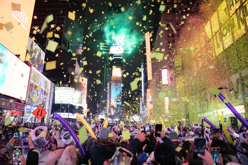 Revelers watch and record as confetti falls over Times Square to celebrate the New Year of 2025 on Jan. 1, 2025.