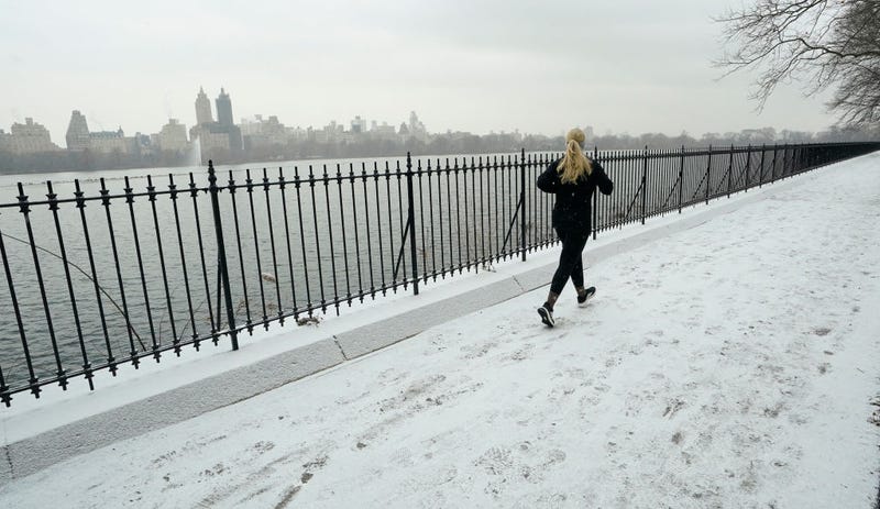 People run around Jacqueline Kennedy Onassis Reservoir in the snow in Central Park Jan. 6, 2025 in New York City as a major winter storm hits the Mid-Atlantic region.