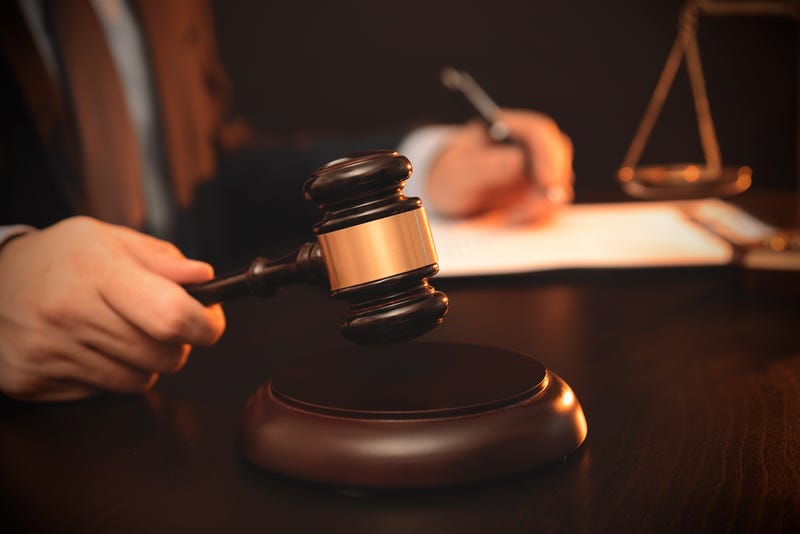 A judge with a gavel in their hand.