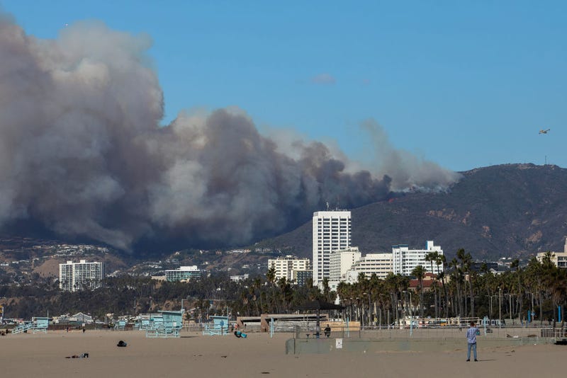 A firefighting aircraft drops the fire retardant Phos-Chek as the Palisades Fire burns amid a powerful windstorm on January 7, 2025 in the Pacific Palisades neighborhood of Los Angeles, California.