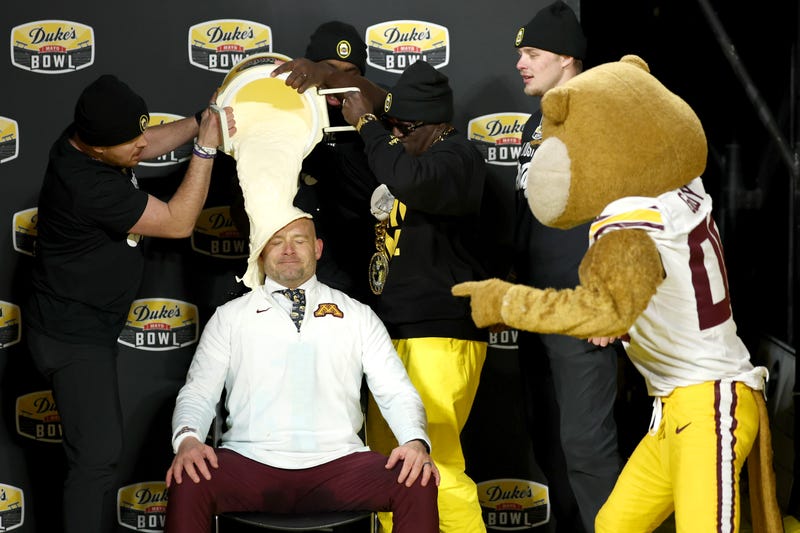 Head coach P.J. Fleck of the Minnesota Golden Gophers gets a mayo bath after winning the Duke's Mayo Bowl against the Virginia Tech Hokies at Bank of America Stadium on January 03, 2025 in Charlotte, North Carolina. 