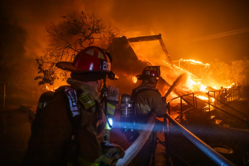 Firefighters fight the flames from the Palisades Fire burning the Theatre Palisades during a powerful windstorm on January 8, 2025/