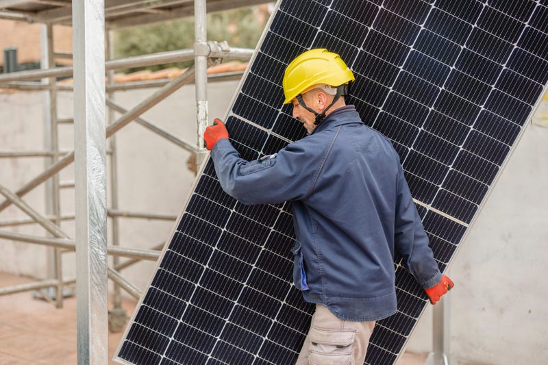 Man carrying solar panels