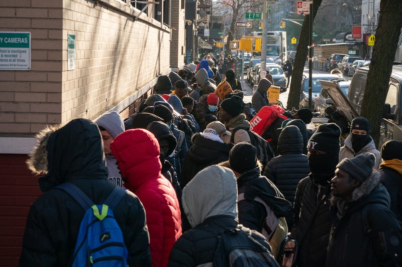 Migrants line up outside a migrant re-ticketing center at St. Brigid School on East 7th St. on Friday, Jan. 5, 2024 in Manhattan