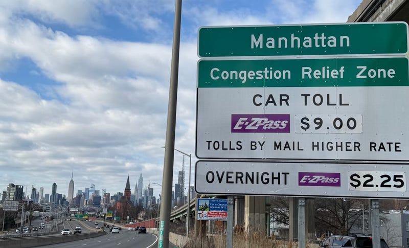 A congestion pricing car toll sign on the westbound Long Island Expressway approaching Van Dam Street in Queens, New York.