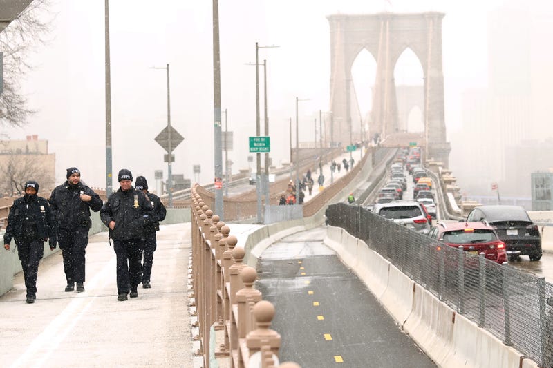 NYPD officers walk along the Brooklyn Bridge on January 6, 2025