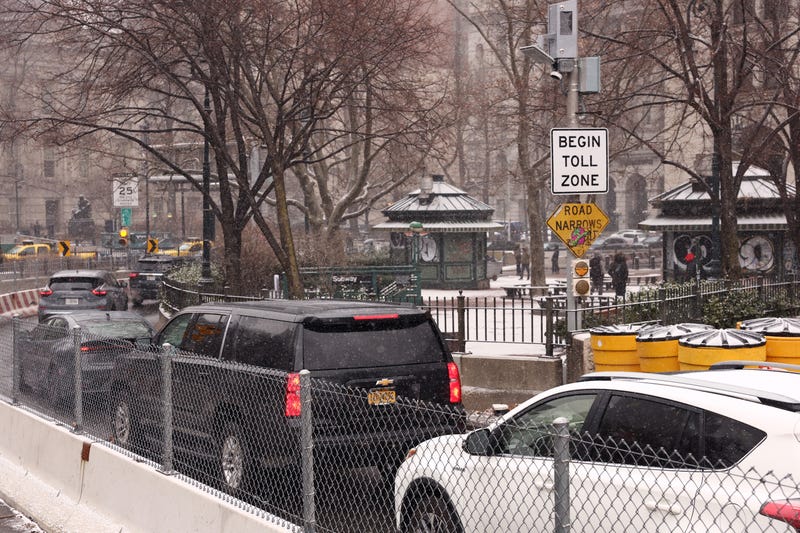 Cars pass a toll sign as they drive into Manhattan on January 6, 2025