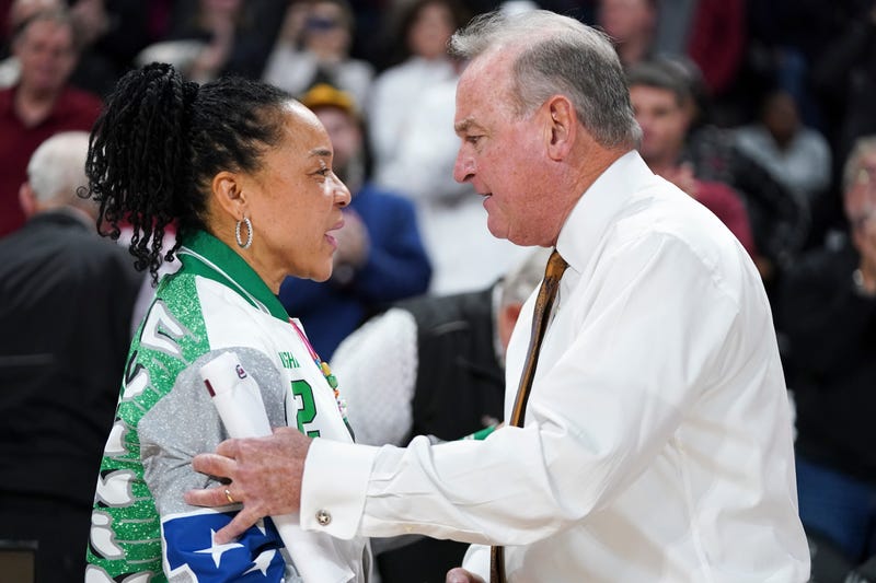 Head coach Dawn Staley of the South Carolina Gamecocks, left, and head coach Vic Schaefer of the Texas Longhorns talk after an NCAA women's basketball game at Colonial Life Arena on January 12, 2024, in Columbia, South Carolina.