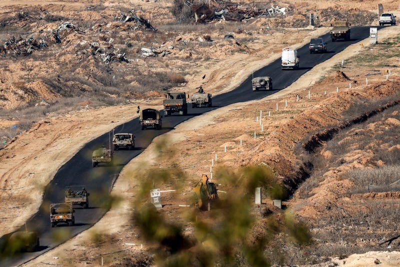 An Israeli army military convoy moves along a road on the border with the Gaza Strip on January 13, 2025