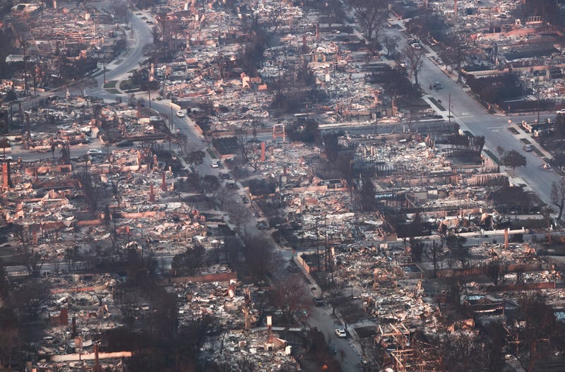 An aerial view shows destroyed homes as the Palisades Fire continues to burn on January 09, 2025 in Pacific Palisades, California.