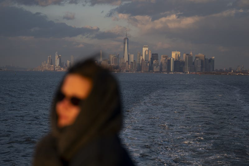 A woman rides the Staten Island ferry away from Manhattan earlier this year