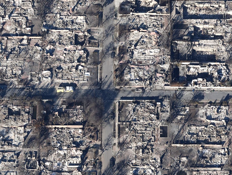 An aerial view of a fire truck near homes destroyed in the Palisades Fire as wildfires cause damage and loss through the LA region on January 13, 2025 in Pacific Palisades, California. 