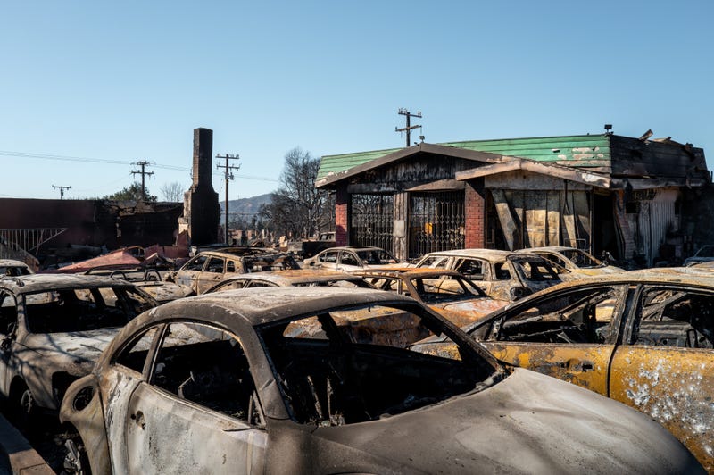 Vehicles destroyed by the Eaton Fire sit in the parking lot of a burned auto shop on January 15, 2025 in Altadena, California.