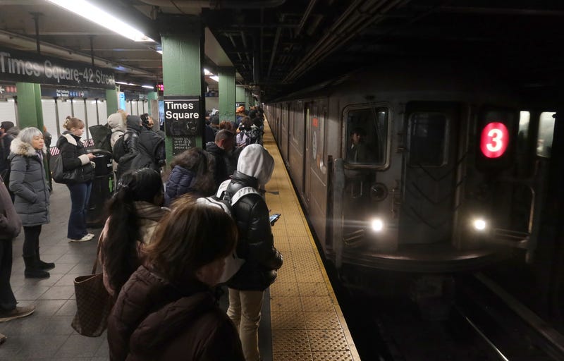 People wait on the platform to board a 3-line train at the Times Square-42nd Street subway station on January 15, 2025