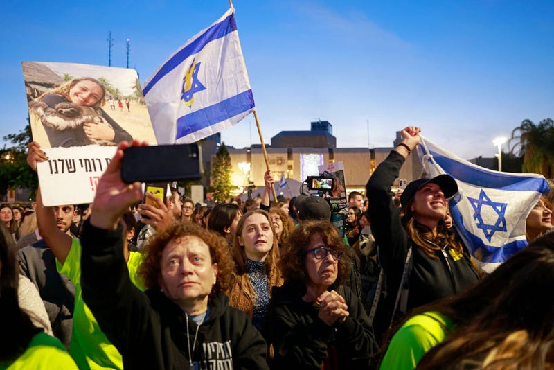 Supporters and relatives of hostages held captive in the Gaza Strip since the Oct. 7, 2023 terrorist attacks by Hamas react while watching a live television broadcast on the release of Israeli hostages, at the Hostages Square in Tel Aviv, on Jan. 19, 2025.