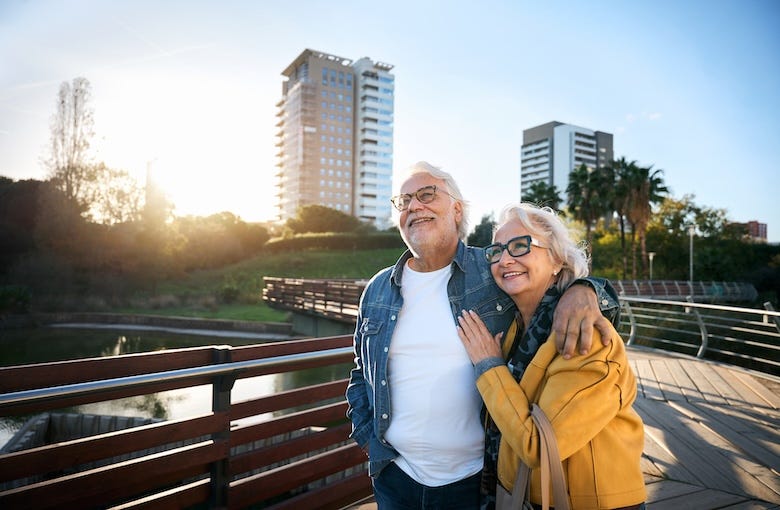 Retired couple walking on a bridge