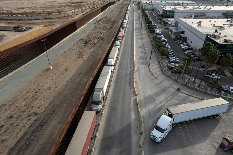 Trucks line up near the border wall before crossing to the United States at Otay commercial port in Tijuana, Mexico, on January 22, 2025