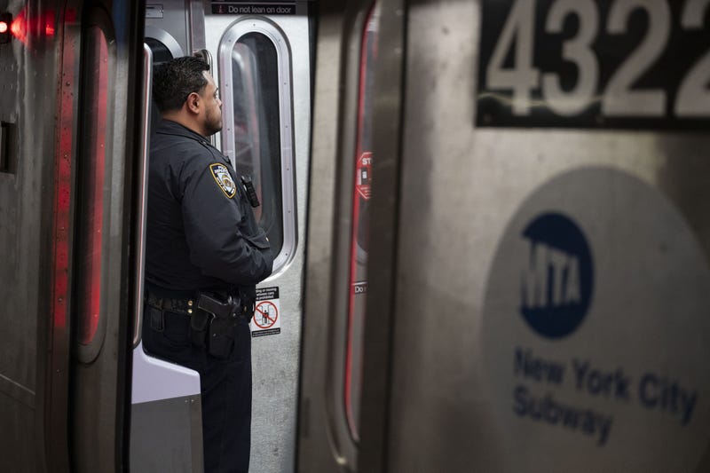 An NYPD officers stands aboard a subway train this month