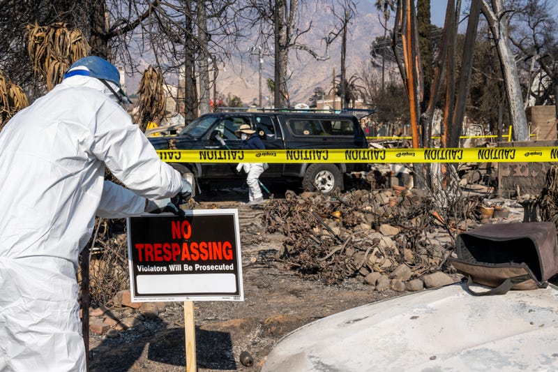 A person erects a "No Trespassing" sign near their property on January 19, 2025 in Altadena, California. 