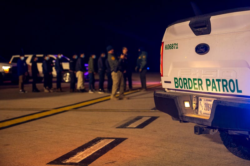 In this handout provided by the U.S. Department of Defense, U.S. Customs and Border Protection Agents guide illegal immigrants to board C-17 Globemaster III aircraft at the Tucson International Airport, on January 23, 2025 in Tucson, Arizona.
