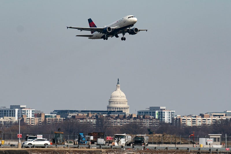 A plane takes off from Reagan National Airport after the crash last night of an American Airlines plane on the Potomac River as it approached the airport on January 30, 2025 in Arlington, Virginia