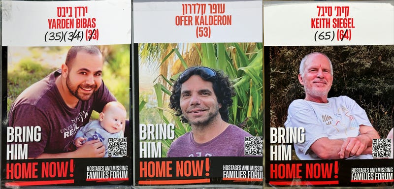 This combination of pictures created on January 31, 2025 shows posters of three Israeli hostages held in the Gaza Strip since the Oct. 7. 2023: Yarden Bibas (L), Ofer Kalderon and Keith Siegel (R)