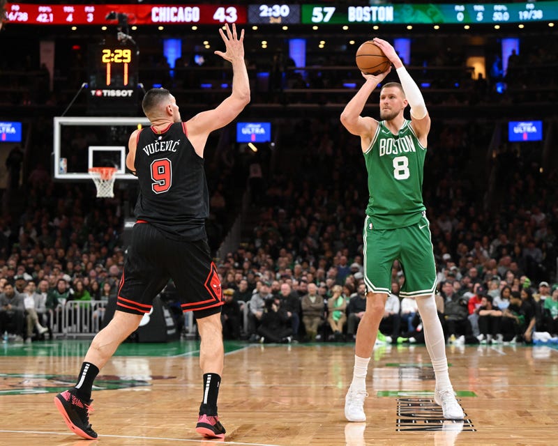 Kristaps Porzingis #8 of the Boston Celtics attempts a three-point basket against Nikola Vucevic #9 of the Chicago Bulls during the second quarter at the TD Garden on January 29, 2025 in Boston, Massachusetts.