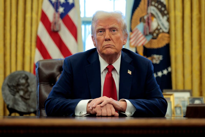 U.S. President Donald Trump talks to reporters from the Resolute Desk after signing an executive order in Washington, DC. 