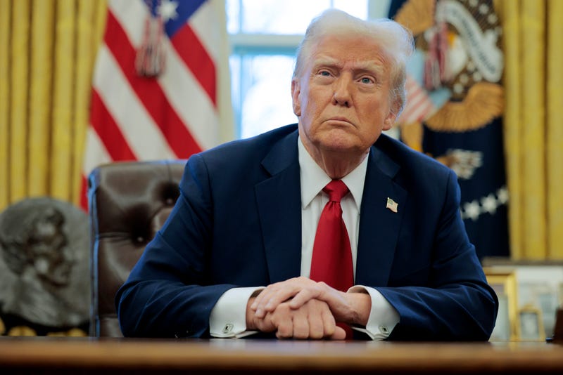 President Donald Trump talks with reporters in the Oval Office of the White House on January 30, 2025