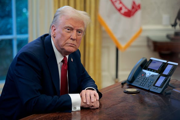 President Donald Trump talks to reporters from the Resolute Desk 