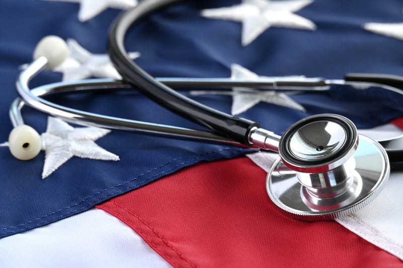 A stethoscope lays on top of an American flag