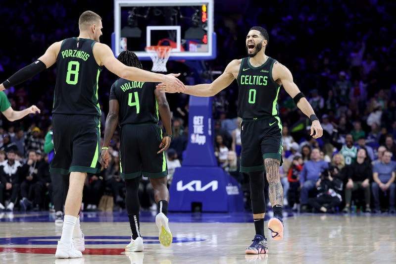 Jayson Tatum #0 of the Boston Celtics celebrates a basket with Kristaps Porzingis #8 during the second half against the Philadelphia 76ers at the Wells Fargo Center on February 02, 2025 in Philadelphia, Pennsylvania.
