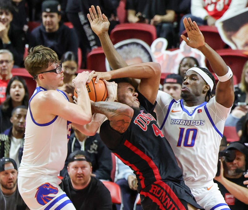 Andrew Meadow #13 of the Boise State Broncos ties up Jeremiah Cherry #45 of the UNLV Rebels for a jump ball as Emmanuel Ugbo #10 of the Broncos defends in the second half of their game at the Thomas & Mack Center on February 04, 2025 in Las Vegas, Nevada.