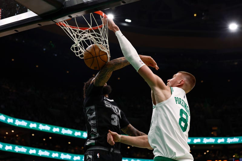 Kristaps Porzingis #8 of the Boston Celtics dunks on Julian Champagnie #30 of the San Antonio Spurs during the second half at TD Garden on February 12, 2025 in Boston, Massachusetts.